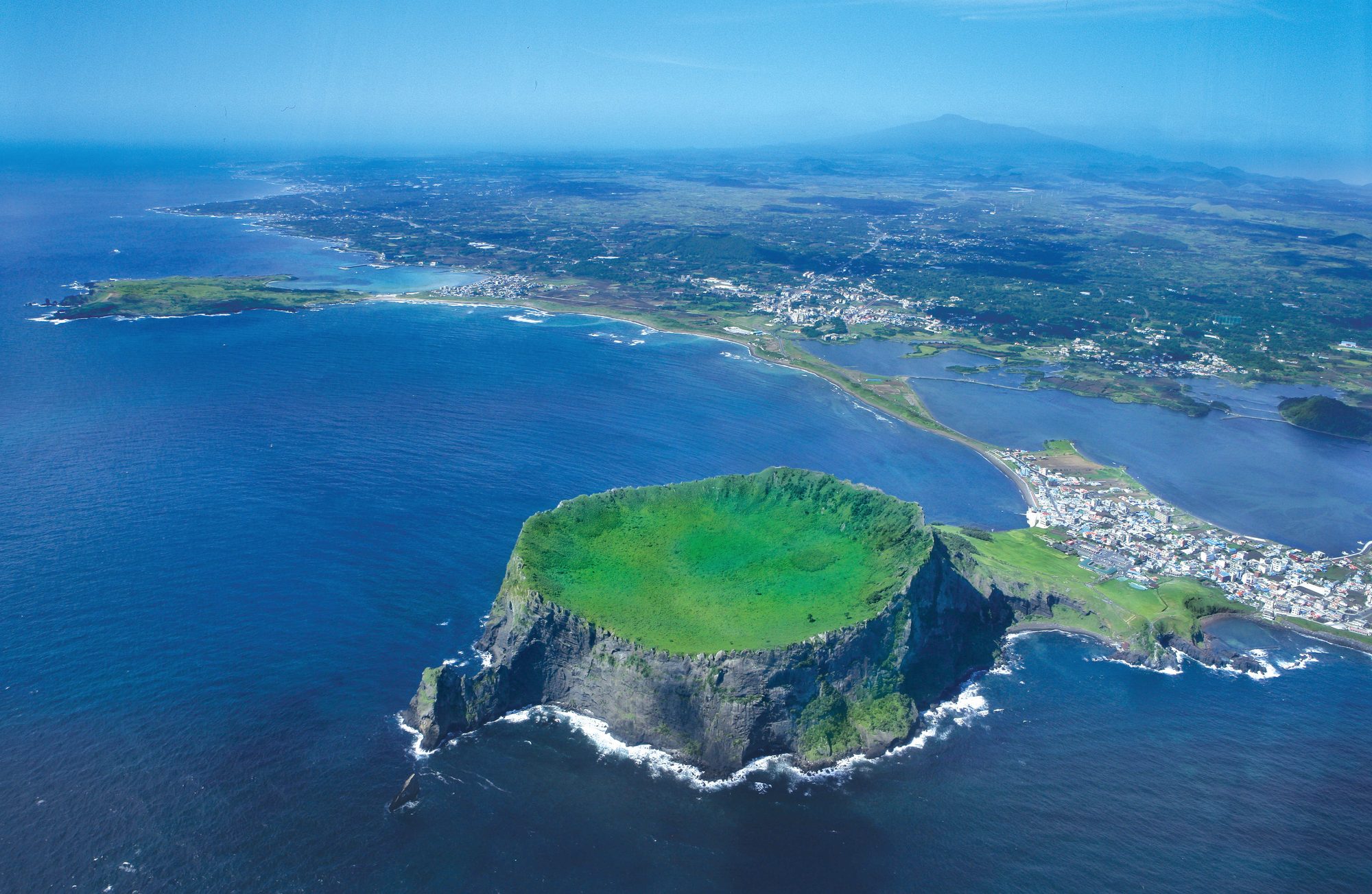Aerial view of Jeju's volcanic coastline meeting the sea